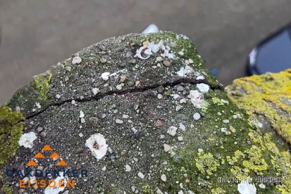 Beschadigde en verweerde nokvorst met scheuren en mos in Eijsden Beschadigde en verweerde nokvorst met scheuren en mos in Eijsden