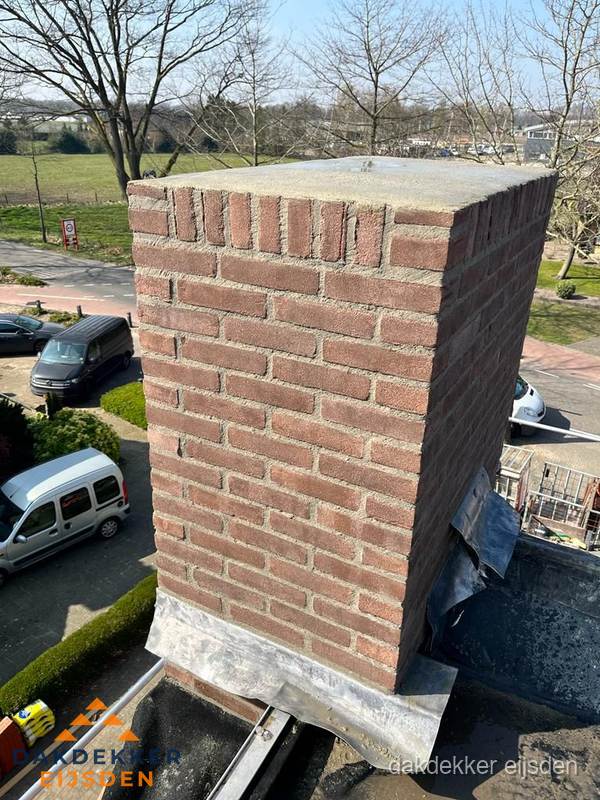 Gemetselde schoorsteen met loodaansluiting op dak in Eijsden Gemetselde schoorsteen met loodaansluiting op dak in Eijsden
